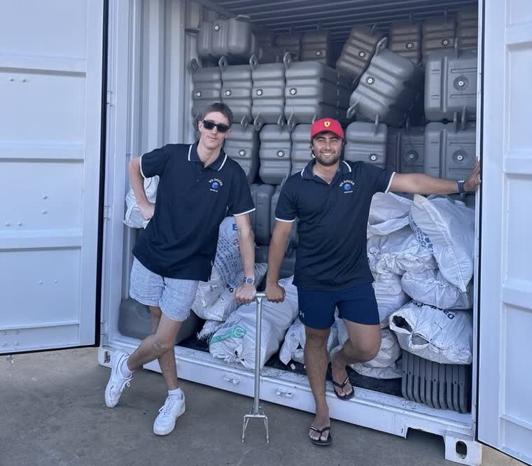 Image of Josh and Damian, founders of WS Docks, standing in front of container of docking materials