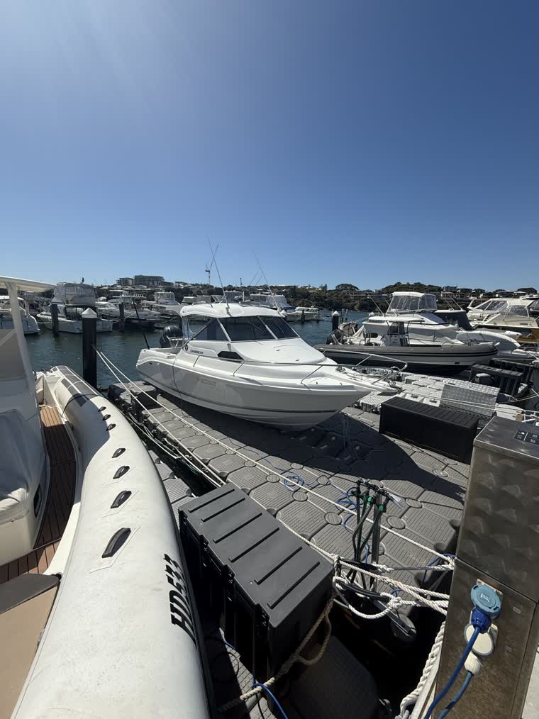 A number of boats docked on a floating dock