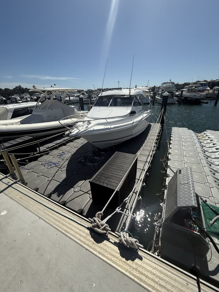 Front view of a boat docked on a floating dock