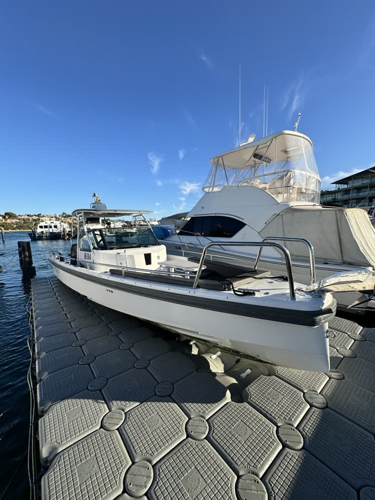 Image of a long boat on a duck on a sunny day