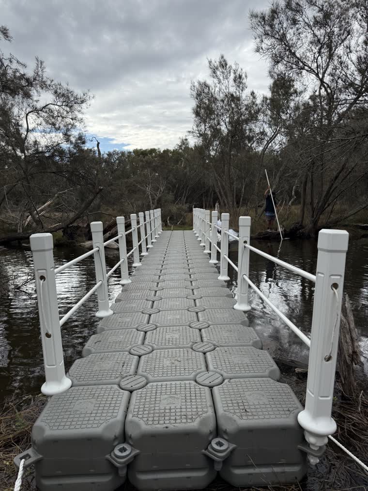 A closeup view of a walkway dock serving as a bridge connecting one piece of land to another