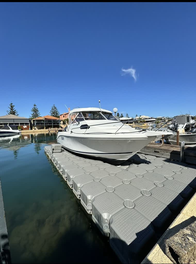 White boat docked on a sunny day